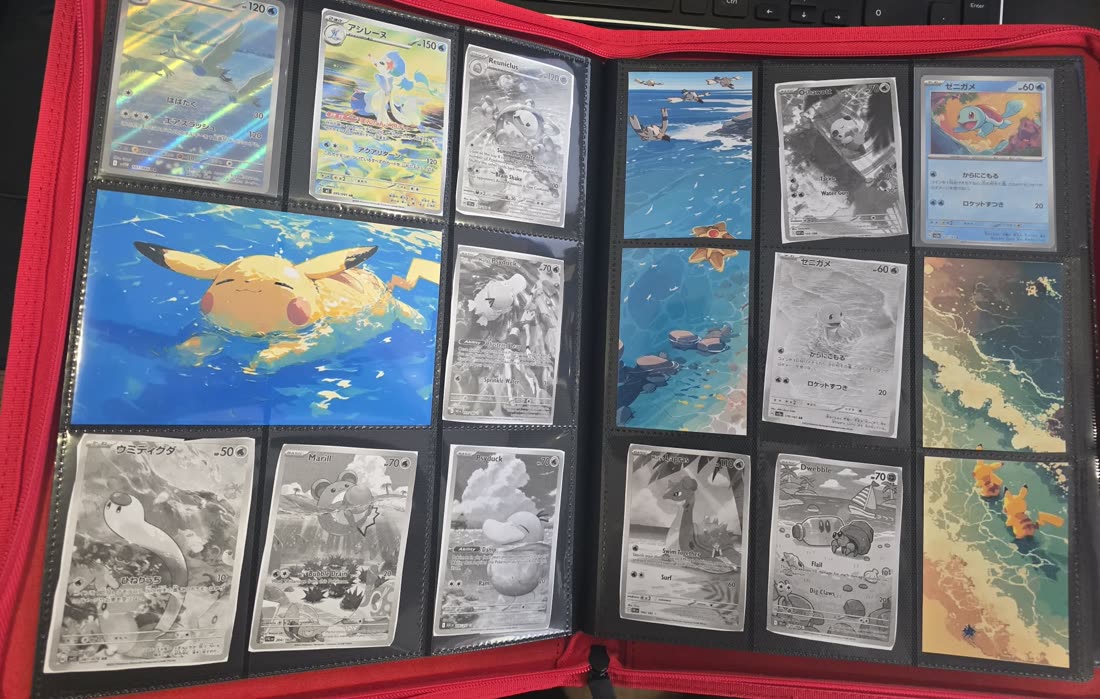An open binder: two pages of printed greyscale placeholder cards next to real Pokémon cards, with artwork spanning pockets on both pages.